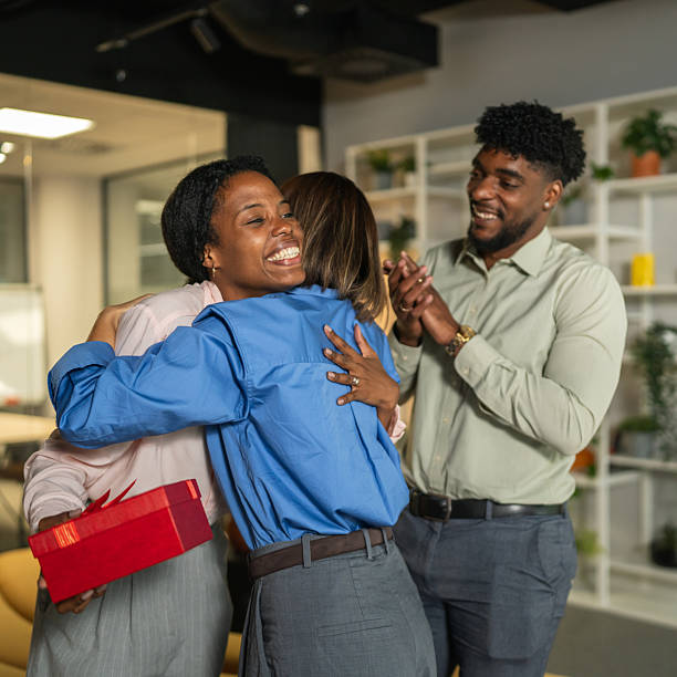 istock Diverse business colleagues congratulating and embracing in office 2249639301