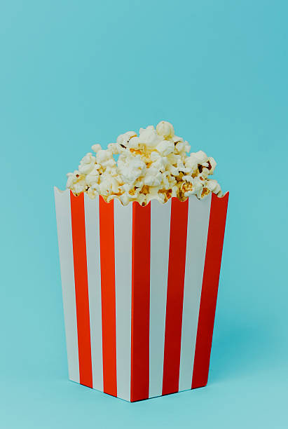 istock Popcorn in a striped box against a light blue background 2249640388