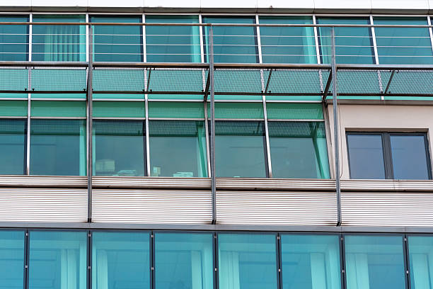 istock Glass facade of a modern building with metal vertical supports and external structural elements 2249643549