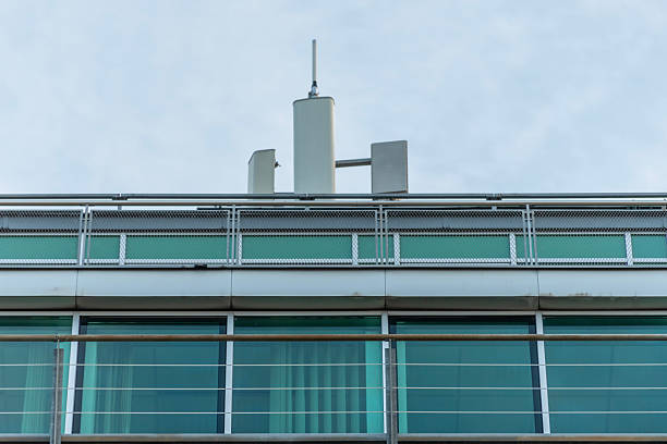 istock The upper part of a modern building with a glass facade, metal railings and technical elements on the roof 2249643569