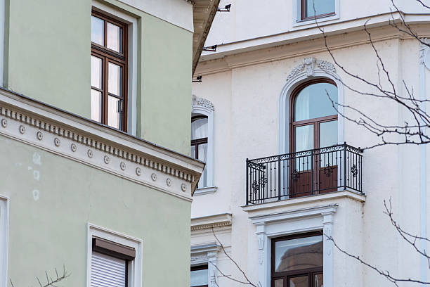 istock Facades of two historic buildings with arched windows, a balcony and decorative elements in a classic urban style 2249643622
