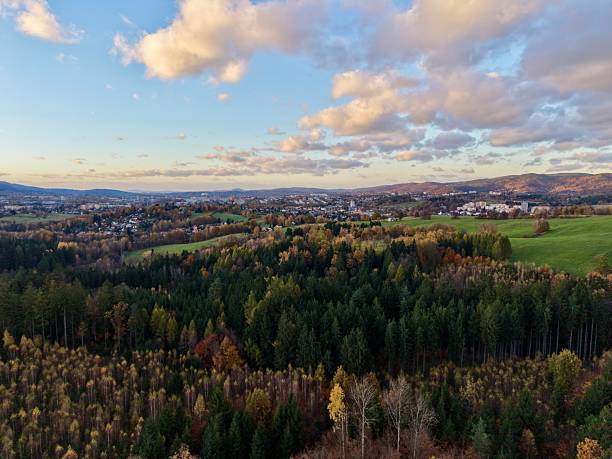 istock aerial scenic panorama, sunshine over hills and fields, flying high above lush land and distant settlements 2249644607
