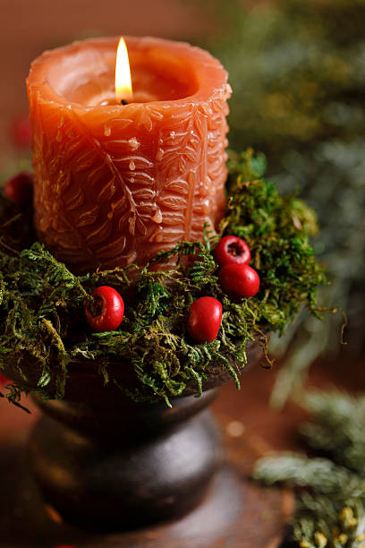 Christmas candle with moss and red berries