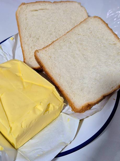 istock Two Slices of Bread with Butter on Kitchen Counter 2249645846