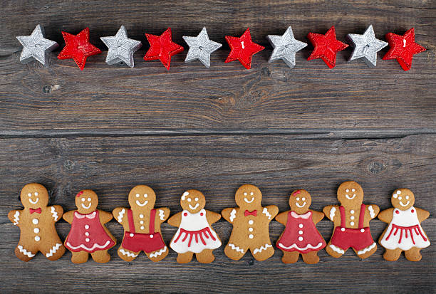 Christmas gingerbread couple cookies and fire tree on rustic wood