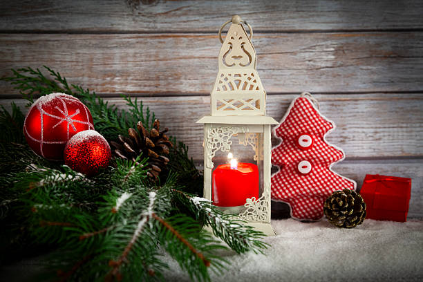 Burning lantern and Christmas decoration on wooden rustic background