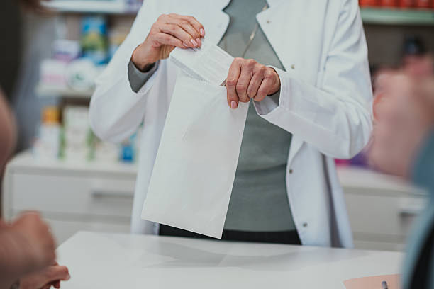 istock Pharmacist dispensing prescription medication to customer in pharmacy 2249648265