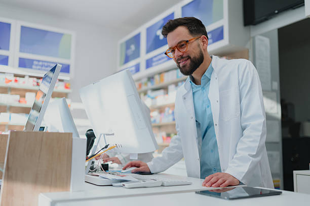 istock Smiling male pharmacist working on computer in pharmacy 2249648285