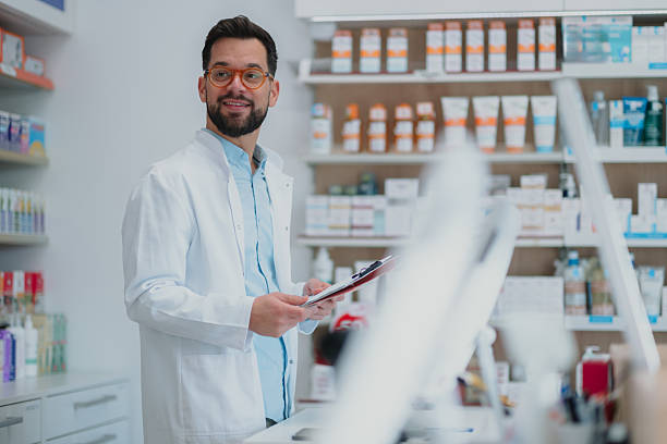 istock Pharmacist professional man standing in drugstore 2249648292