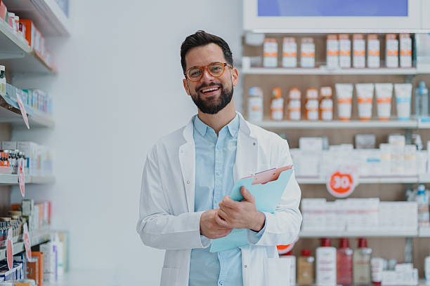 istock Smiling male pharmacist holding clipboard in pharmacy 2249648296