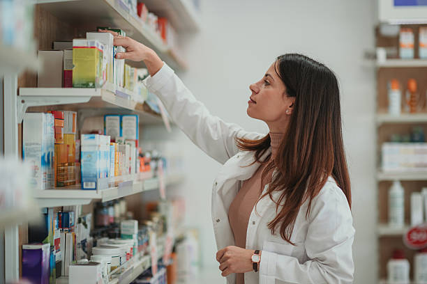 istock Pharmacist reaching for medicine on pharmacy shelf 2249648838