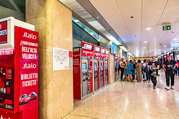 MILAN, ITALY - October 12, 2025:  Tourists are buying train tickets at the ticket machine. The view of Milano Centrale railway station, Milan, Milan, Italy.