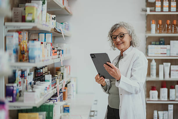 istock Senior pharmacist checking inventory in modern pharmacy 2249648876