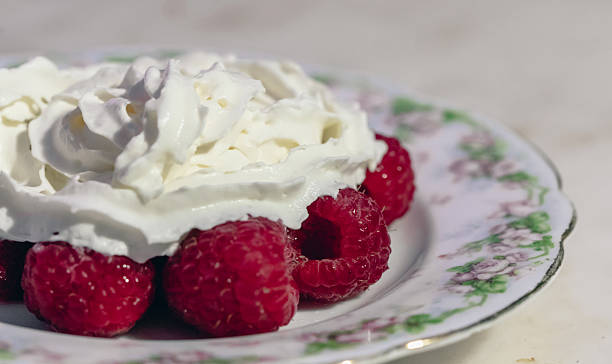 istock Fresh Raspberry Dessert With Whipped Cream On Floral Plate — Delicious Fruit Treat 2249649026
