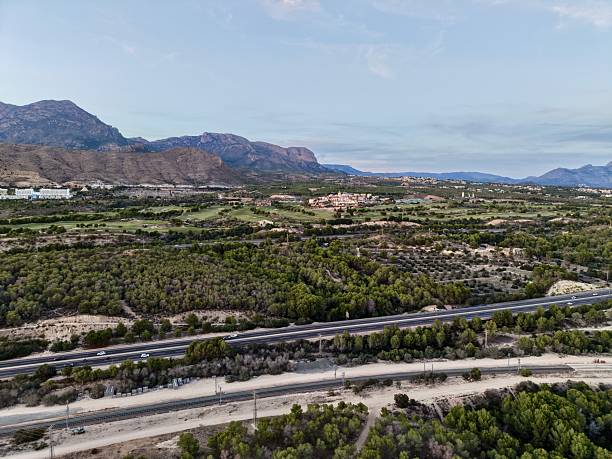 istock bright valley with winding roadway, tranquil journey along multilane route through scenic landscapes 2249649958