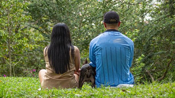 istock couple walking with their pet 2249654400