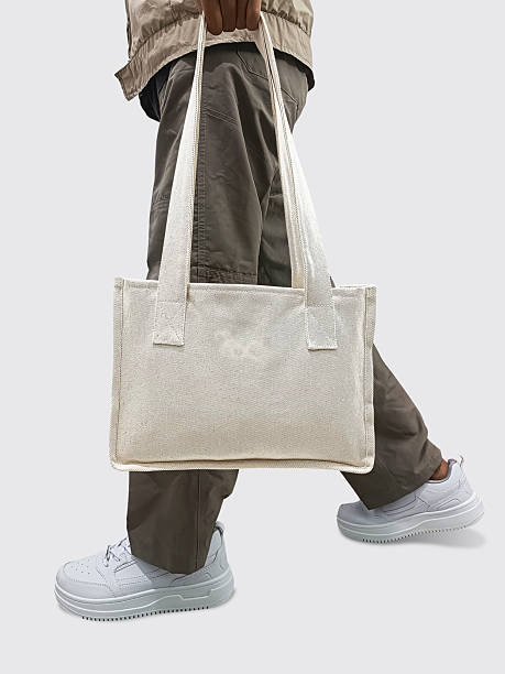 istock A man holding a white tote bag on a white background 2249655657