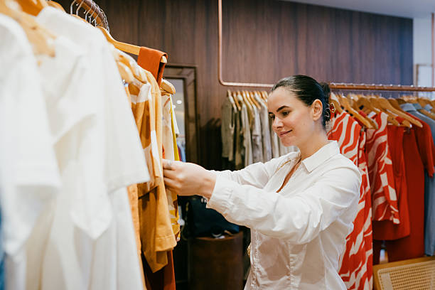 istock Customer browsing curated womenswear collection in retail store 2249657458