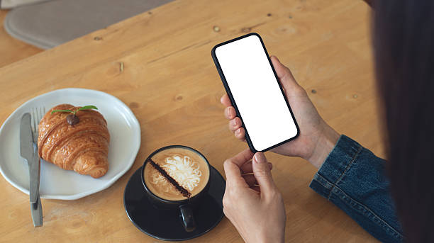 istock Mockup, blank screen cell phone. Woman hand holding, using mobile phone at cafe with white empty space for advertise text. contact business, social meida communication, technology device, closeup 2249657903