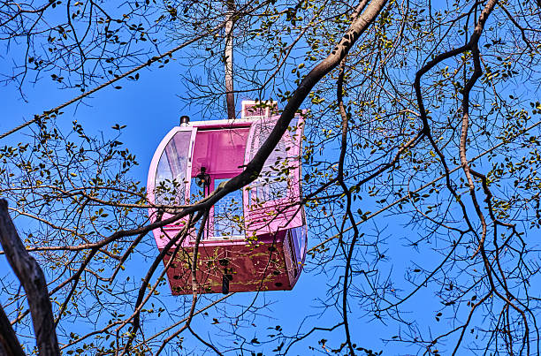 Red overhead cable car cabin in the mountains