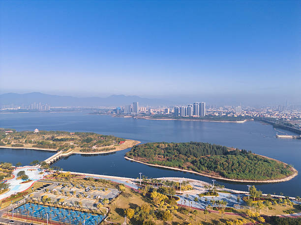 istock Panoramic View of Urban Lakeside Park and Building Complex 2249664768