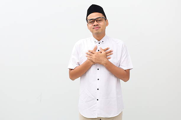 istock Relieved young asian muslim man touching his chest while looking at the camera 2249666370