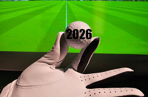 Golf enthusiast displaying a ball marked with the year 2026, preparing for an indoor practice session concept