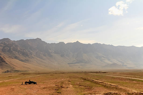 Aerial view of distant highway in desert and village