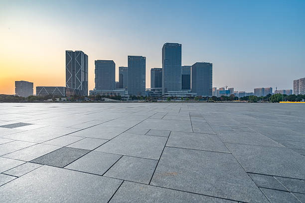 istock Panoramic skyline and buildings with concrete square floor at sunset 2249672845