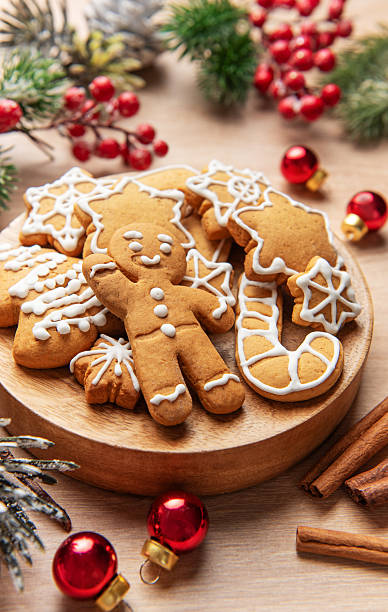 istock Gingerbread cookies on wooden plate with christmas decor 2249675304