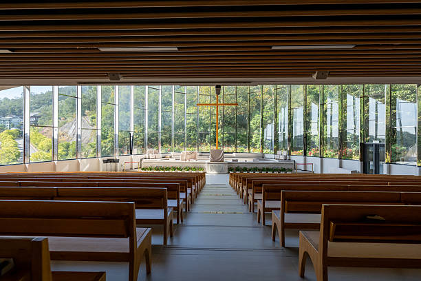 Sunlight shines on the rows of neatly arranged chairs inside the church.