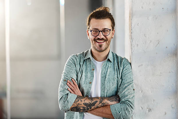 istock Confident hipster man standing by the wall. 2249676394