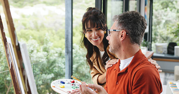 istock Canvas, couple and support with painting in home for creative activity, self expression and hobby. Artist, happy mature people and palette with easel for custom artwork, exhibition project or bonding 2249676744