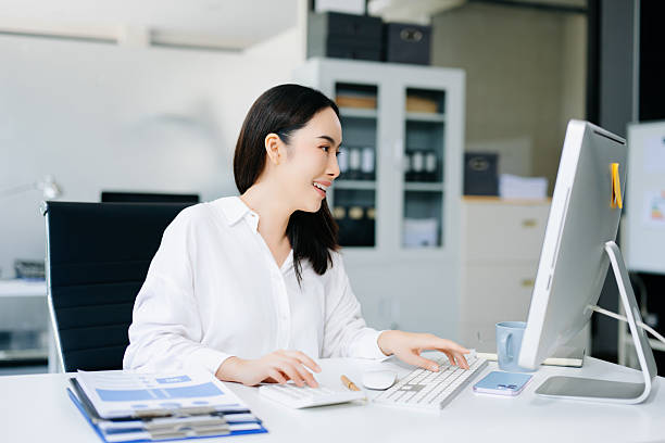 istock Confident Asian businesswoman talking on smartphone and using calculator in modern office. Perfect for finance, communication, business, and productivity concepts. 2249676830