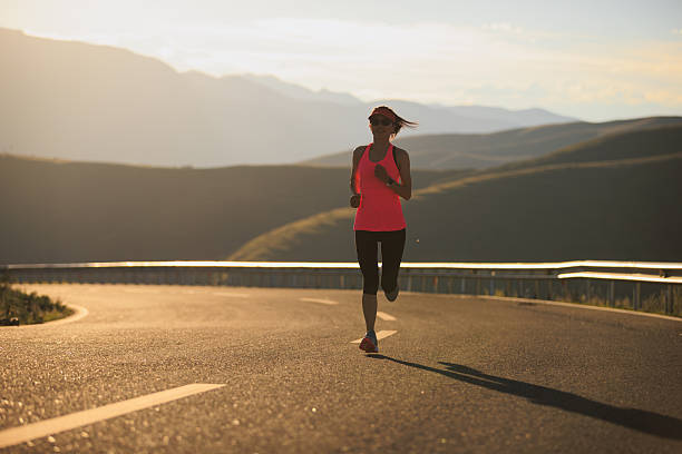 istock Woman runner running in sunset mountain road 2249676998