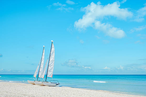 istock Sailboats anchored on a sandy beach under a clear blue sky 2249677707