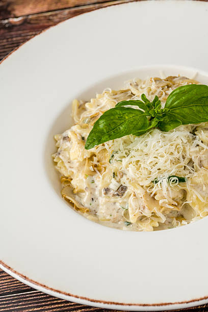 istock Creamy mushroom pasta topped with grated Parmesan and fresh basil 2249677749