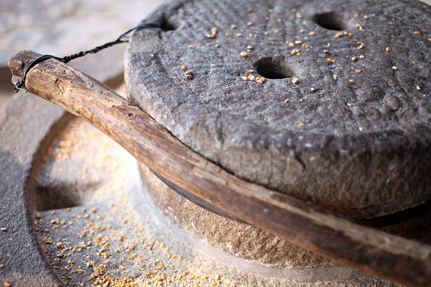 A girl grinds flour from a stone to marry.