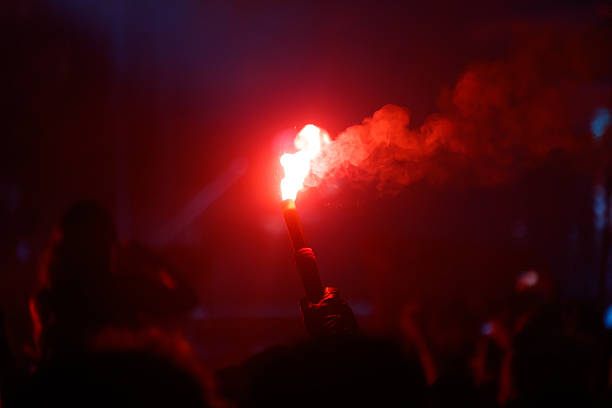 istock A person holding a red lit torch in a dark room 2249679626