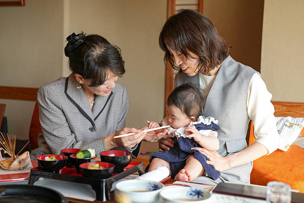 istock A woman is feeding a baby with chopsticks 2249681225