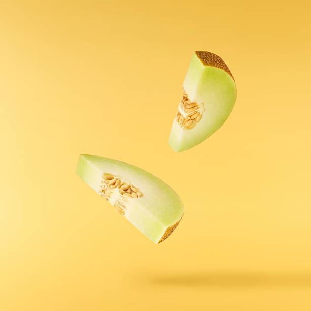 istock Fresh ripe Galia Melon falling in the air isolated on yellow background 2249681288