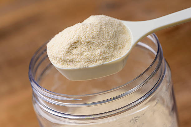 istock Protein Powder Scooped with Measuring Spoon from Storage Jar 2249682253