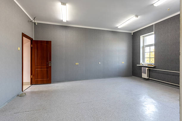 istock Empty Office Room with Grey Walls and Bright Windows 2249683124