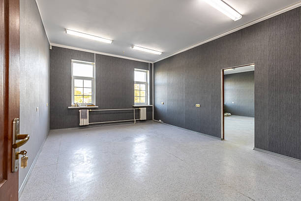 istock Empty Office Room with Grey Walls and Bright Windows 2249683133