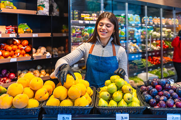 istock Female worker arranging fresh produce inside grocery store 2249683794