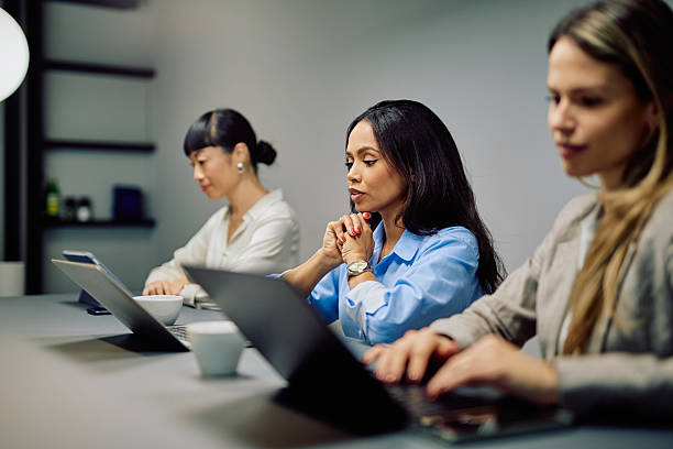 istock Diverse businesswomen working on laptops in modern office 2249686248