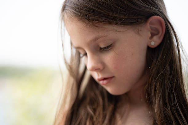 Portrait of a serene young girl enjoying a tranquil moment by the pool, eyes closed and wearing a peaceful expression, embodying joy and contentment under the warm summer sun