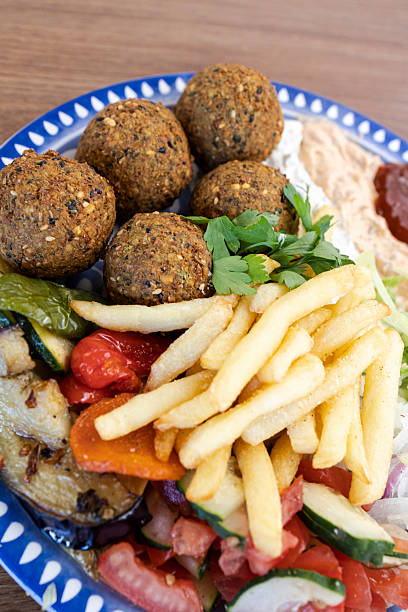 Falafel plate with fries, hummus, and fresh salad for lunch