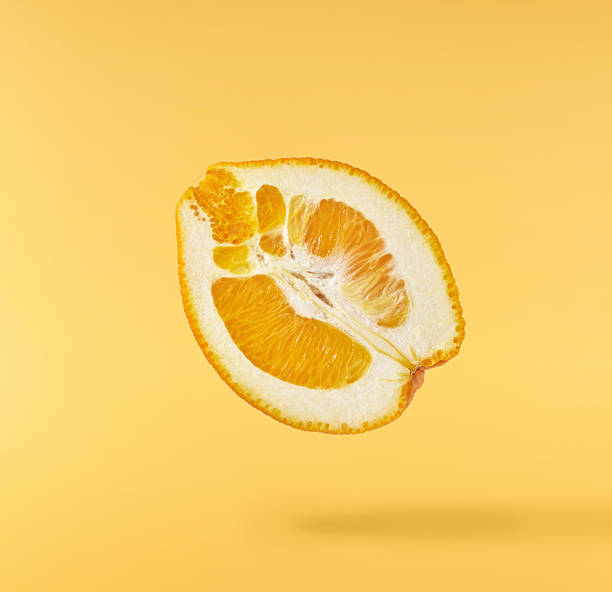 istock Fresh juicy orange slices floating on a vibrant yellow background. Creative citrus levitation concept for healthy food, summer vibes, advertising, packaging, and design projects. 2249686604