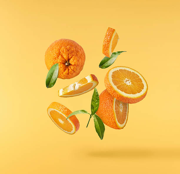istock Fresh juicy orange slices floating on a vibrant yellow background. Creative citrus levitation concept for healthy food, summer vibes, advertising, packaging, and design projects. 2249686612